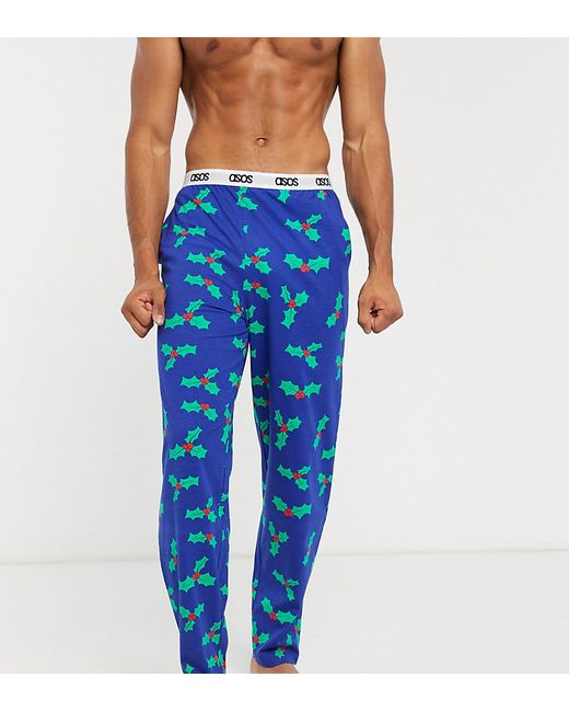 Asos Design Holidays lounge pyjama bottoms with holly print and branded