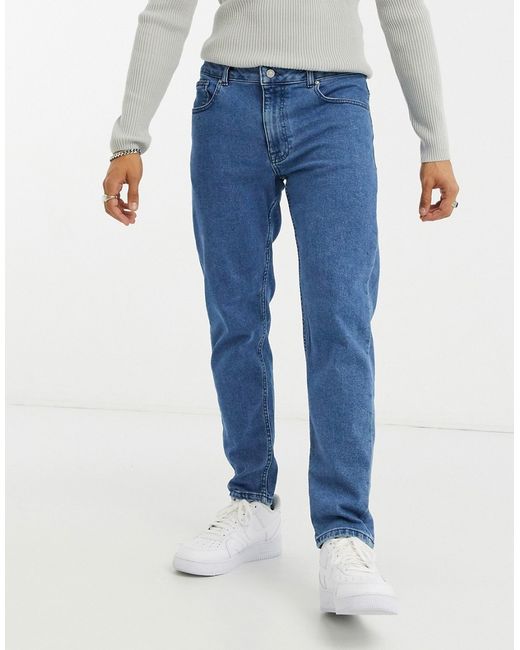 Asos Design stretch tapered jeans in retro mid wash