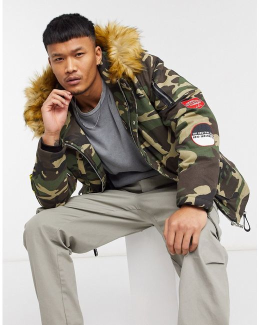 The Couture Club faux fur hooded parka coat with badges in camo print-