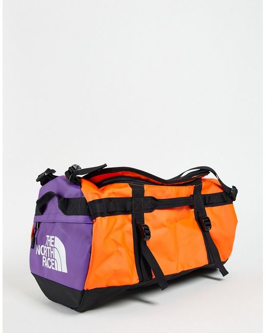 The North Face Base Camp small 50L duffel bag in orange/blue-