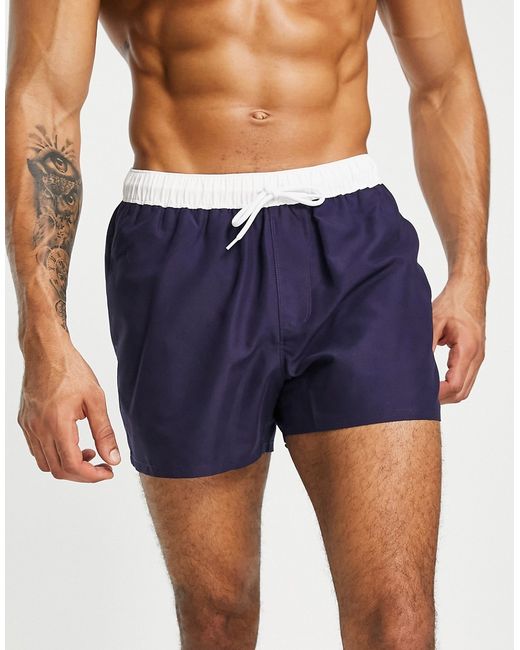 Asos Design swim shorts in navy with white tipping-