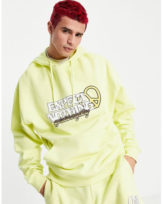 Asos Design oversized hoodie in yellow with text print part of a set-