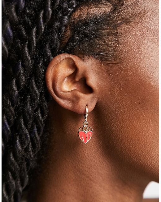 Madein. Madein flame heart earrings in red and