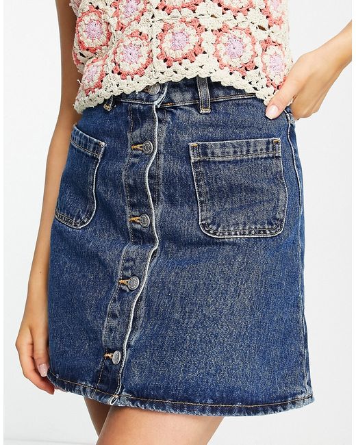 Monki button through mini skirt with front pockets in mid wash denim-