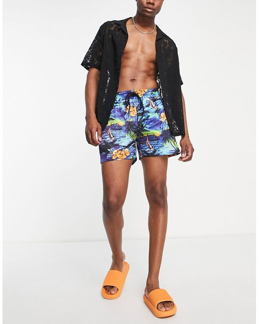 Reclaimed Vintage Inspired recycled swim shorts in tropical beach scene-