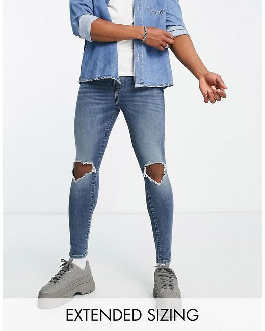 Asos Design spray on jeans with power stretch in mid wash knee rips
