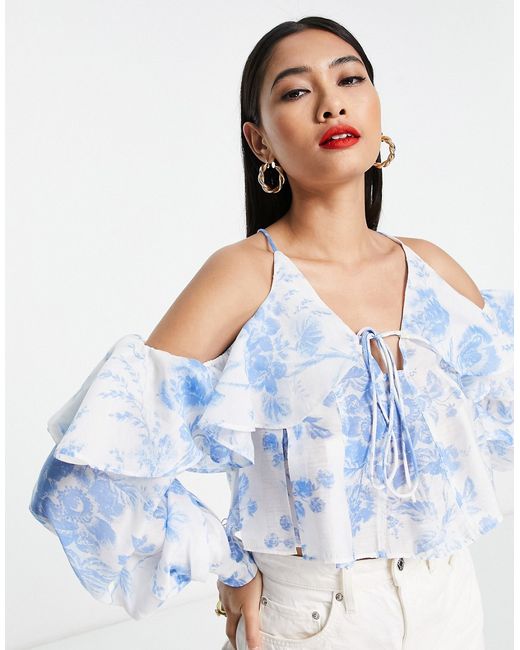 Asos Design ruffle blouse with lace up back in blue floral-