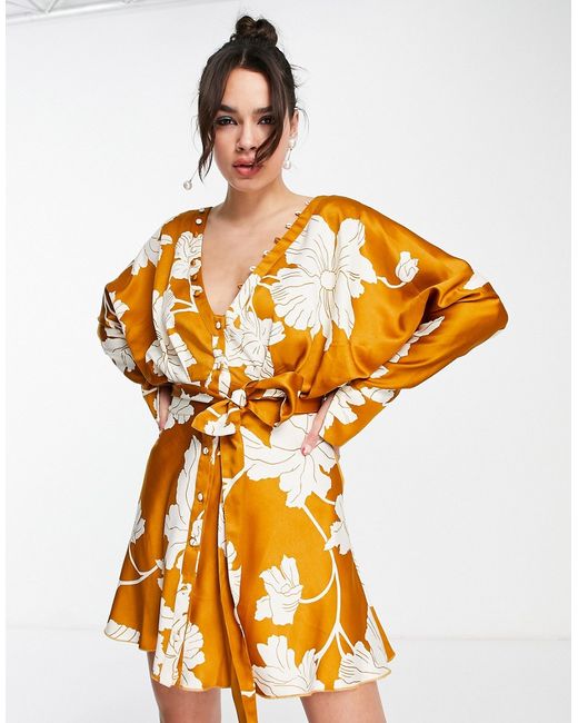 Asos Design batwing satin mini dress with button front detail and tie in mustard floral print-