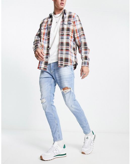 Pull & Bear carrot fit jeans with rips in