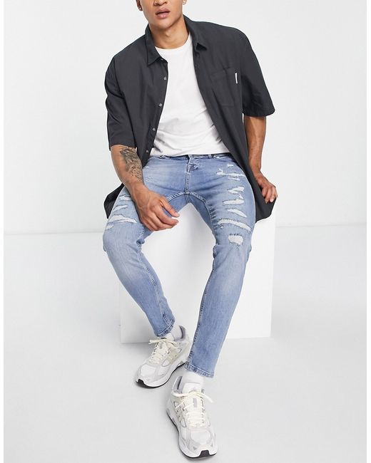 Topman stretch taper rip and repair jeans in mid wash
