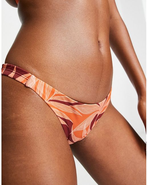 Accessorize tanga bikini bottom in tropical print-