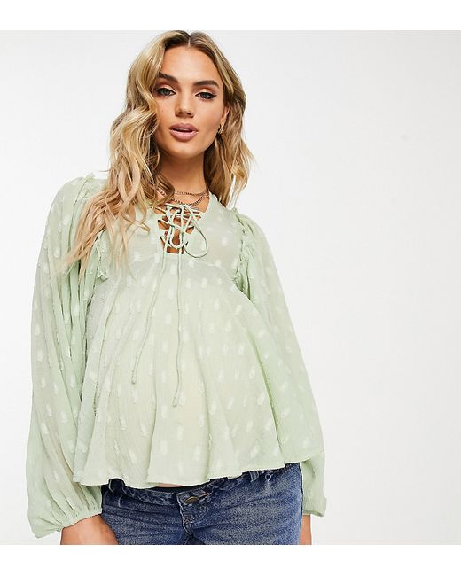 Asos Design Maternity textured long sleeve blouse with lace up front peplum hem in sage-
