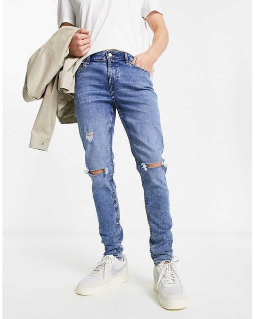 Asos Design skinny jeans in mid wash with rips