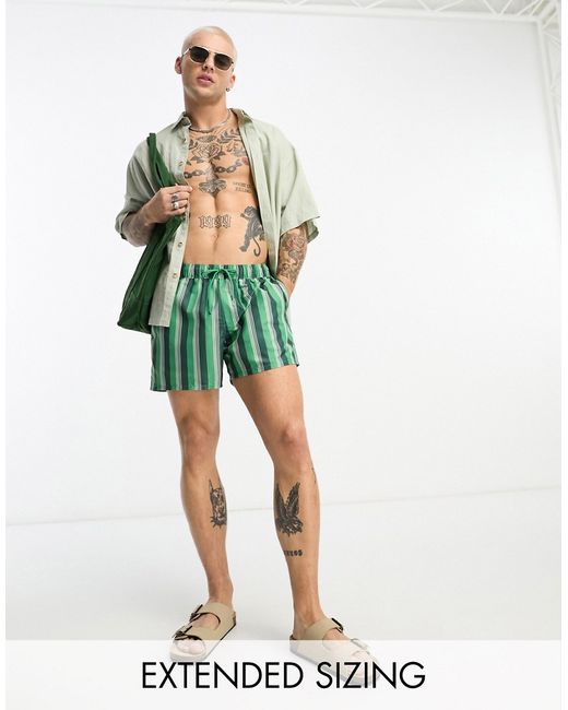 Asos Design swim shorts in short length green stripe-
