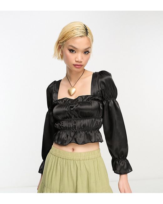 Reclaimed Vintage long sleeve satin ruffle top with tie back in black-