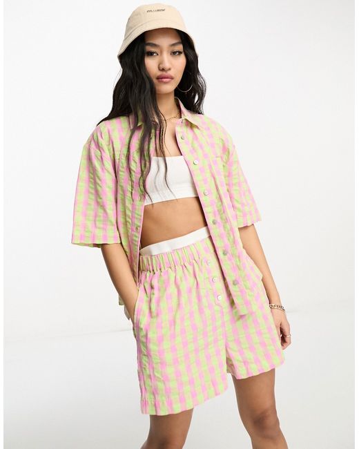 Asos Design boxy shorts with buttons in pink and green check part of a set-