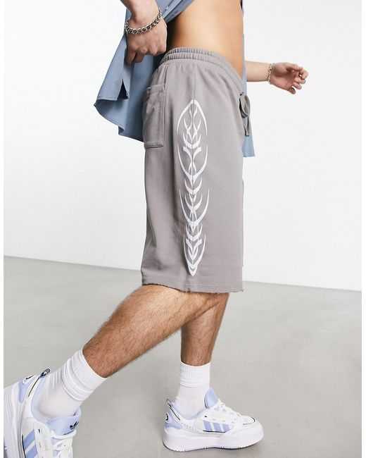 Asos Design oversized basketball shorts in with side print and nibbling
