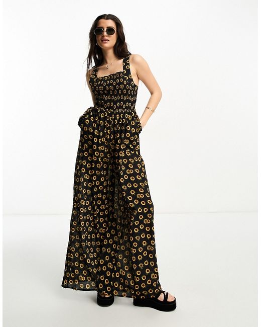 Asos Design shirred pinafore jumpsuit in sunflower print-