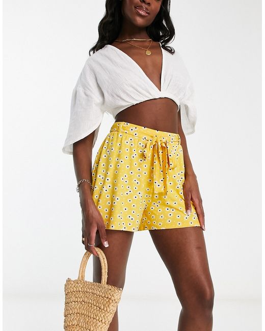 Asos Design tie belt flippy shorts in mustard ditsy floral-