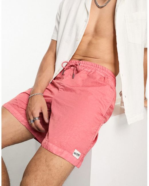 GUESS Originals washed nylon shorts in peach-