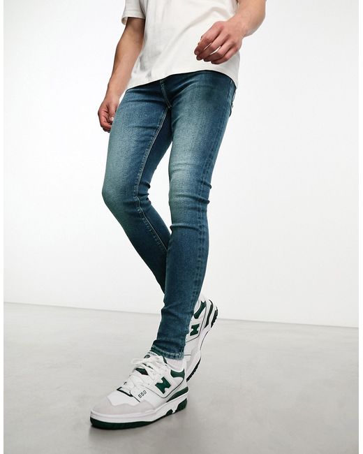 Asos Design power stretch jeans in mid wash