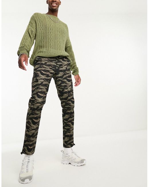 Asos Design cargo tapered pants in camo print with toggles-