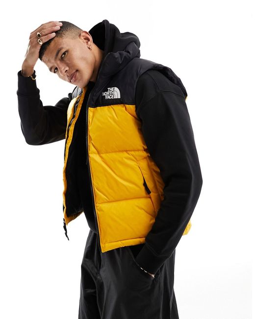 The North Face 1996 Nuptse down puffer vest and yellow