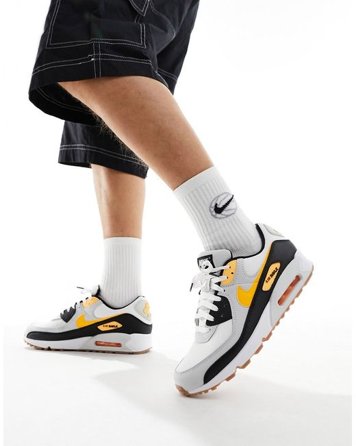 Nike Air Max 90 trainers and yellow