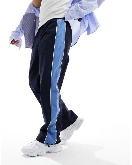 Asos Design baggy track pants with blue side stripe