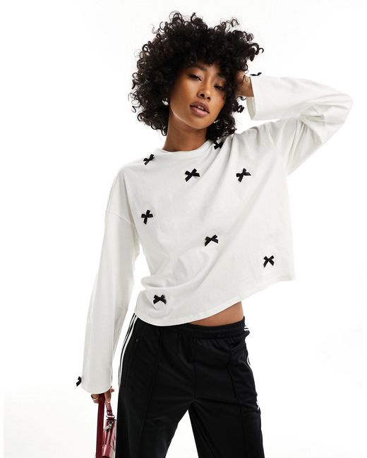Monki long sleeve top with contrasting satin bows light off