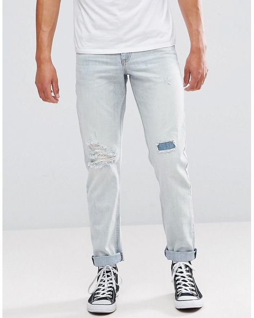Asos Stretch Slim Jeans In Bleach Wash With Rip And Repair