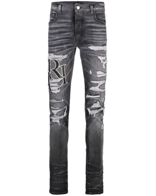 Amiri logo-print ripped skinny jeans