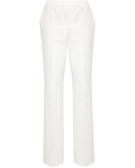 Moschino patch-detail cotton trousers