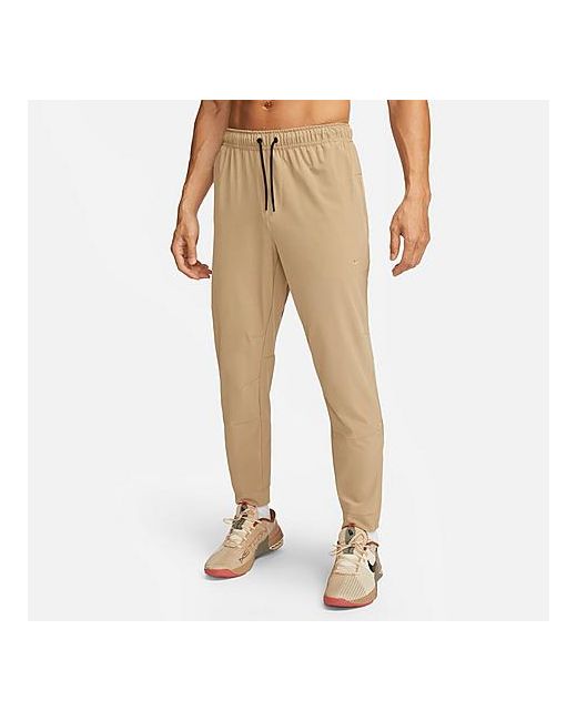 Nike Dri-FIT Unlimited Tapered Leg Versatile Training Pants in Beige Small