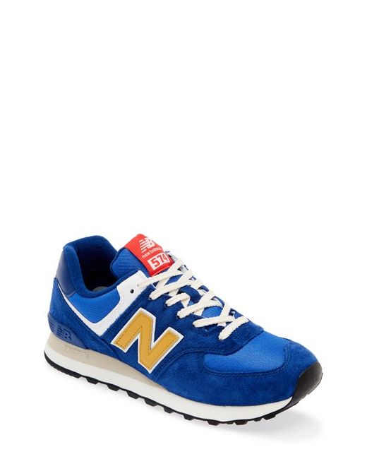 New Balance Gender Inclusive 574 Sneaker in Navy/Gold at 8.5