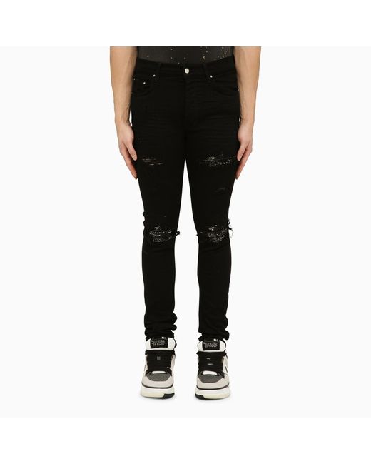 Amiri skinny jeans with camouflage patches